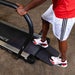 Body-Solid Endurance Walking Treadmill T50 User stepping onto Endurance T50 treadmill ramp for easy access