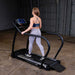 Body-Solid Endurance Walking Treadmill T50 Woman walking on Endurance T50 treadmill in home gym setting