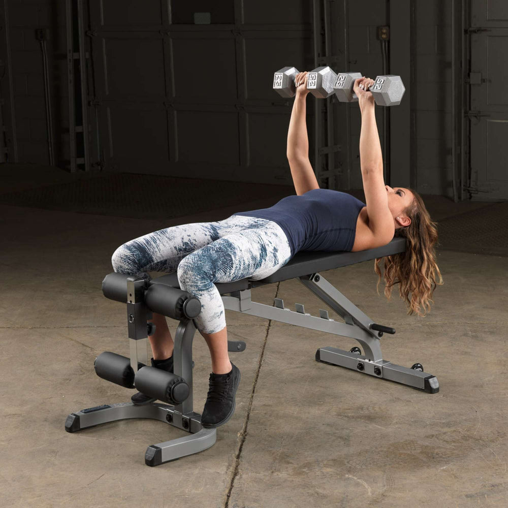 Body-Solid Flat Incline Decline Bench GFID31  Woman doing dumbbell chest press on  FID bench with leg developer