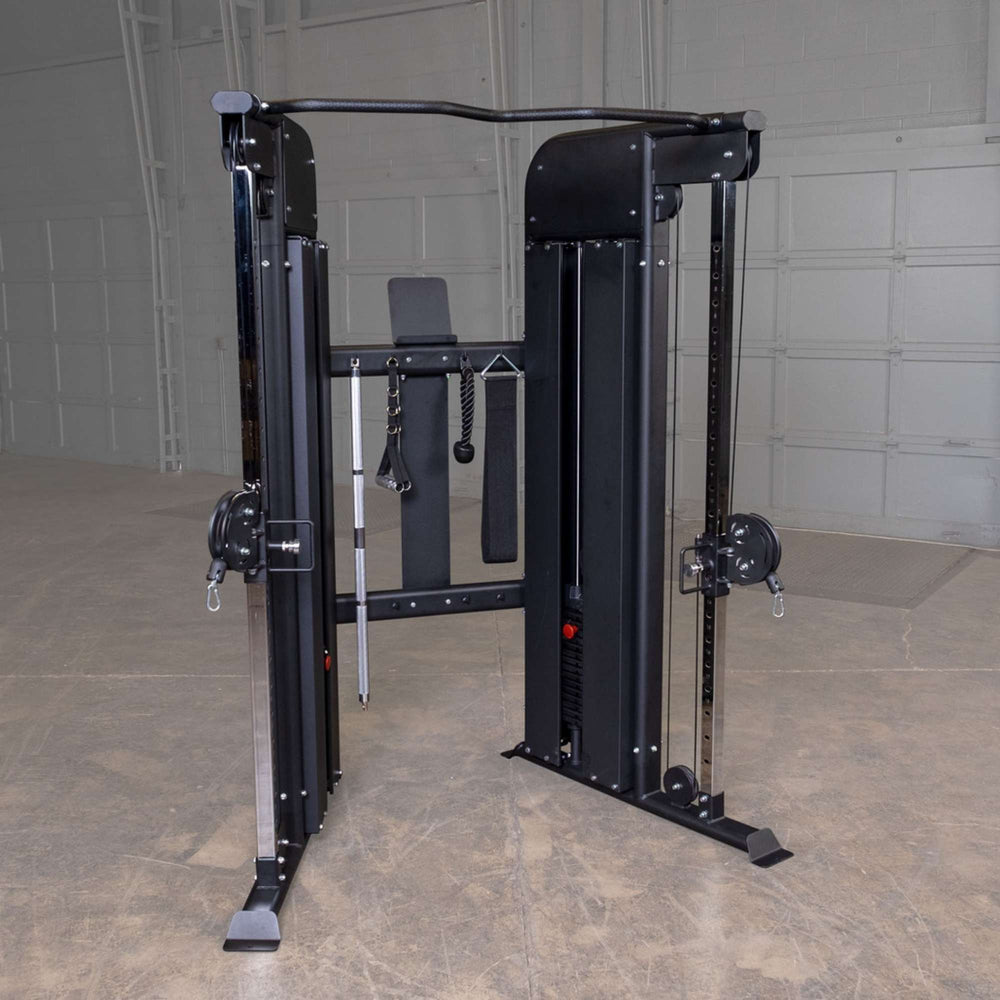 Body-Solid Functional Trainer Shrouds GFT100SH Body-Solid functional trainer with twin adjustable pulleys, multiple cable attachments, and pull-up bar in an industrial-style gym setting.