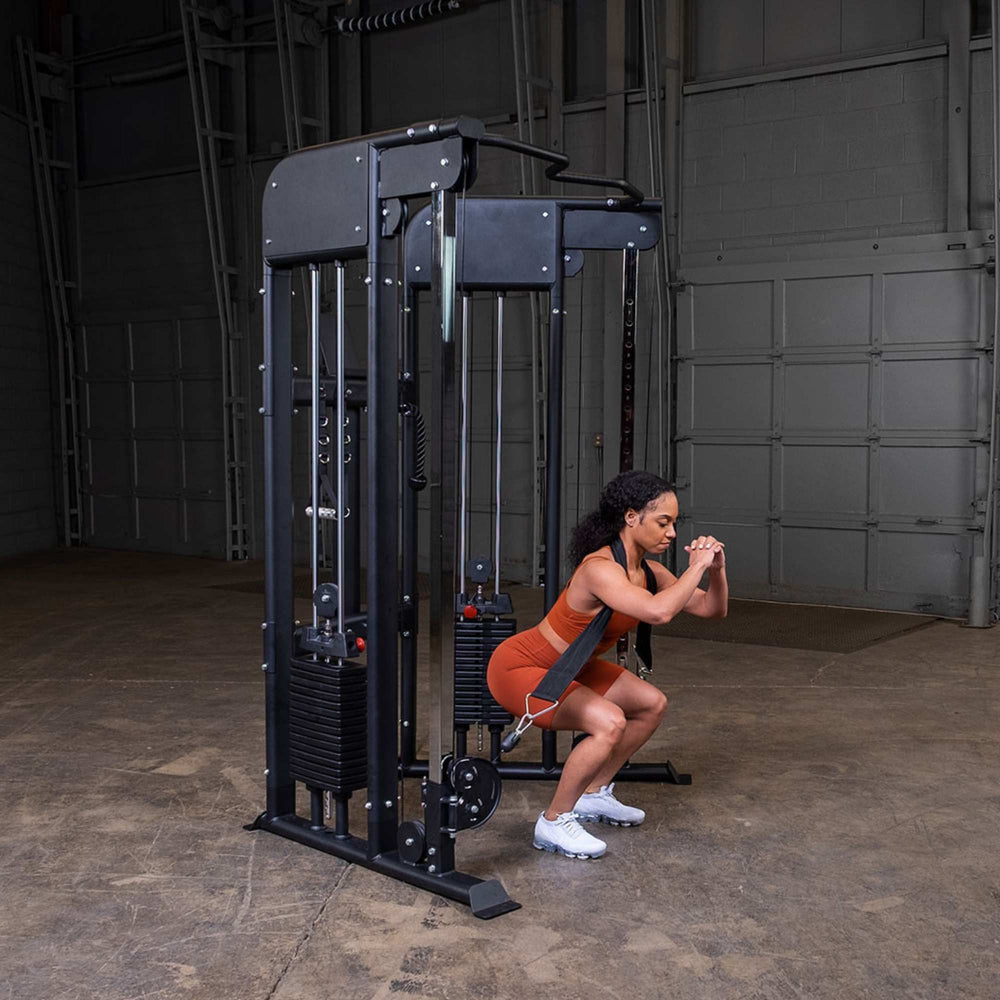 Body-Solid GFT100 Functional Trainer GFT100 used for a cable-assisted squat exercise