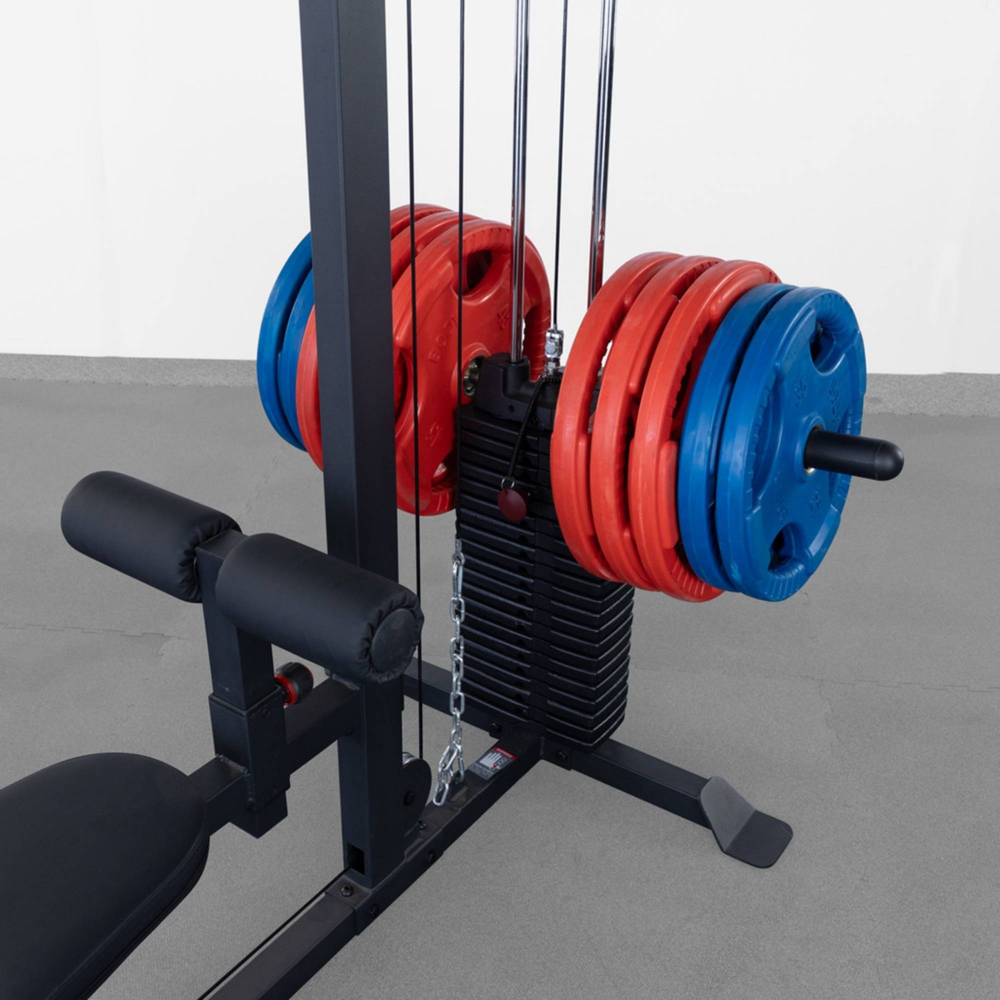 Body-Solid Lat Machine With Weight Stack GLM85B Close-up view of weight stack loaded with red and blue plates 
