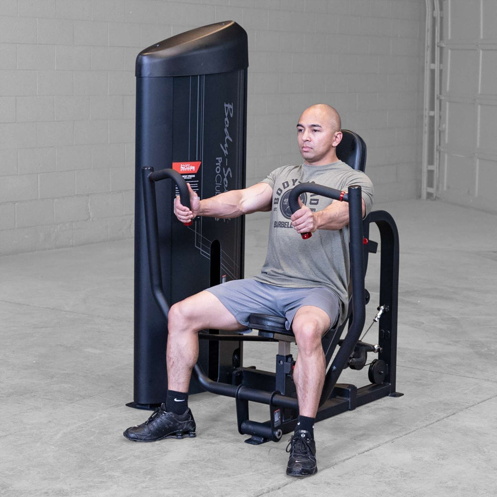 Body-Solid PCL2 Chest Press S2CPX Man performing a chest press on a Body-Solid Pro Club Line machine, arms extended forward, demonstrating exercise form.

