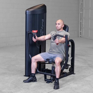 Body-Solid PCL2 Chest Press S2CPX Man performing a chest press on a Body-Solid Pro Club Line machine, arms extended forward, demonstrating exercise form.
