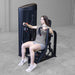 Body-Solid PCL2 Chest Press S2CPX Woman performing a chest press on a Body-Solid Pro Club Line machine, arms extended forward, seated in a workout area