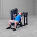 Body-Solid PCL2 Multi Press S2MPX Man seated performing a close-grip chest press on the weight machine.