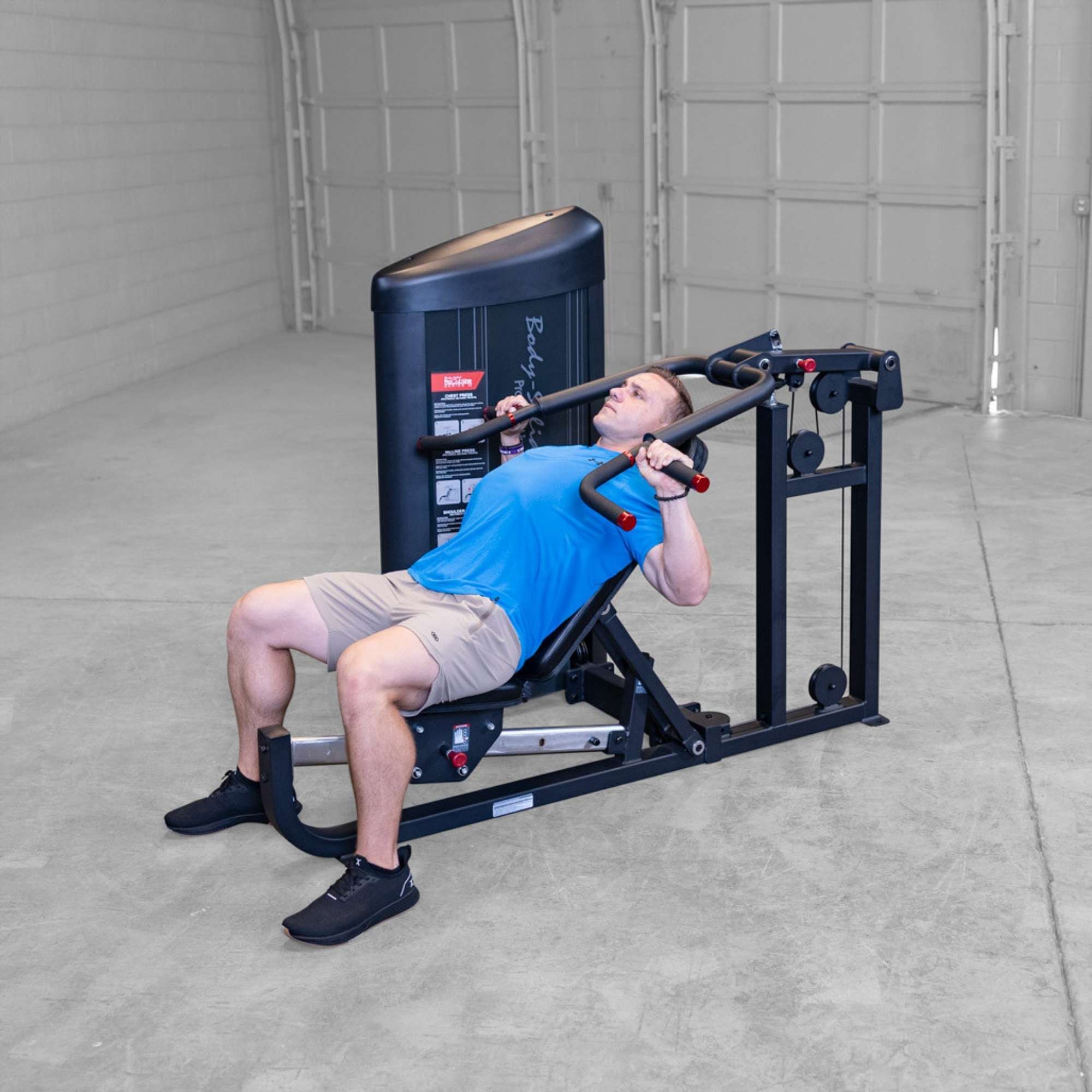 Body-Solid PCL2 Multi Press S2MPX Man seated performing an incline shoulder press looking upward