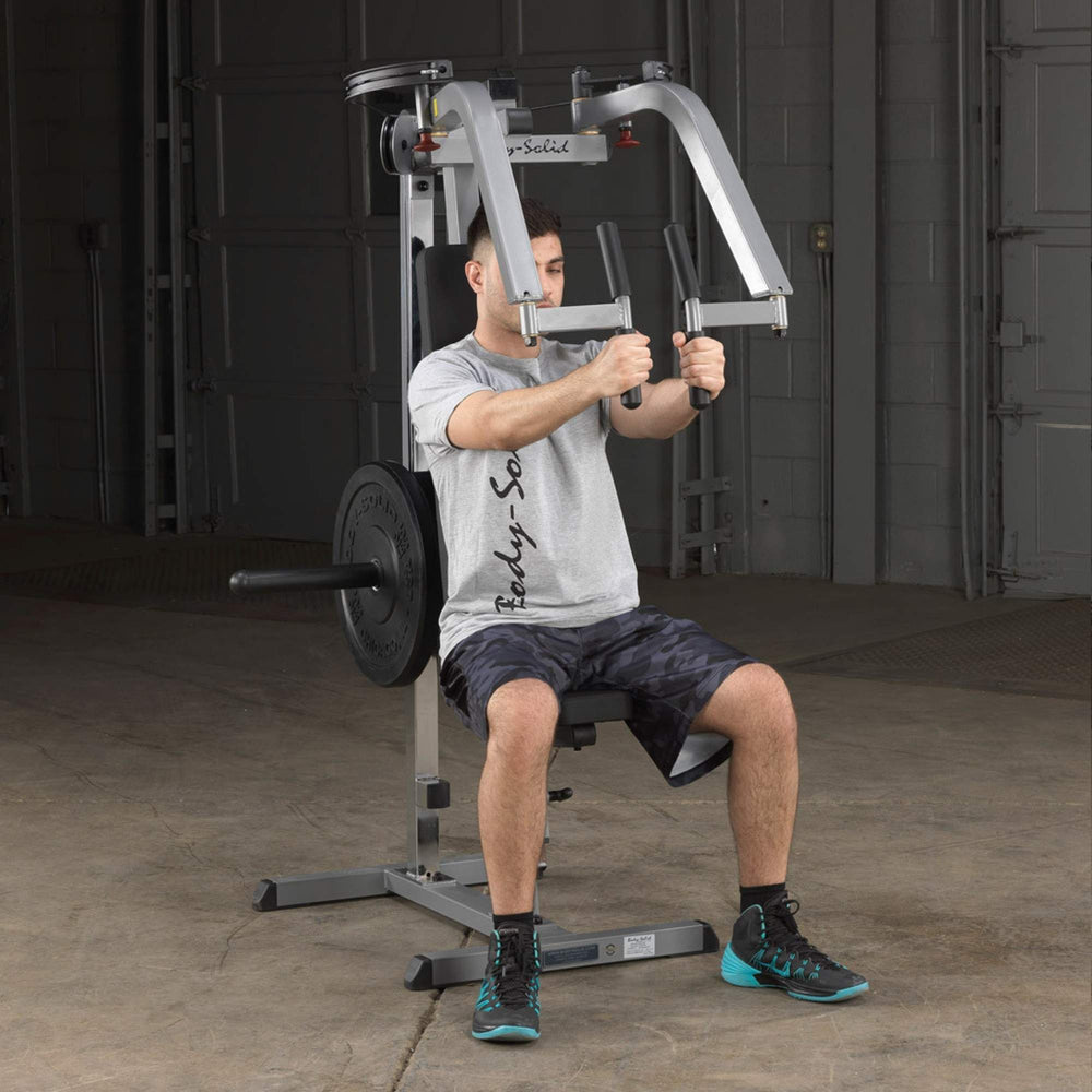 Body-Solid Plate Loaded Pec Deck GPM65B Man performing front pec deck exercise using the push handles