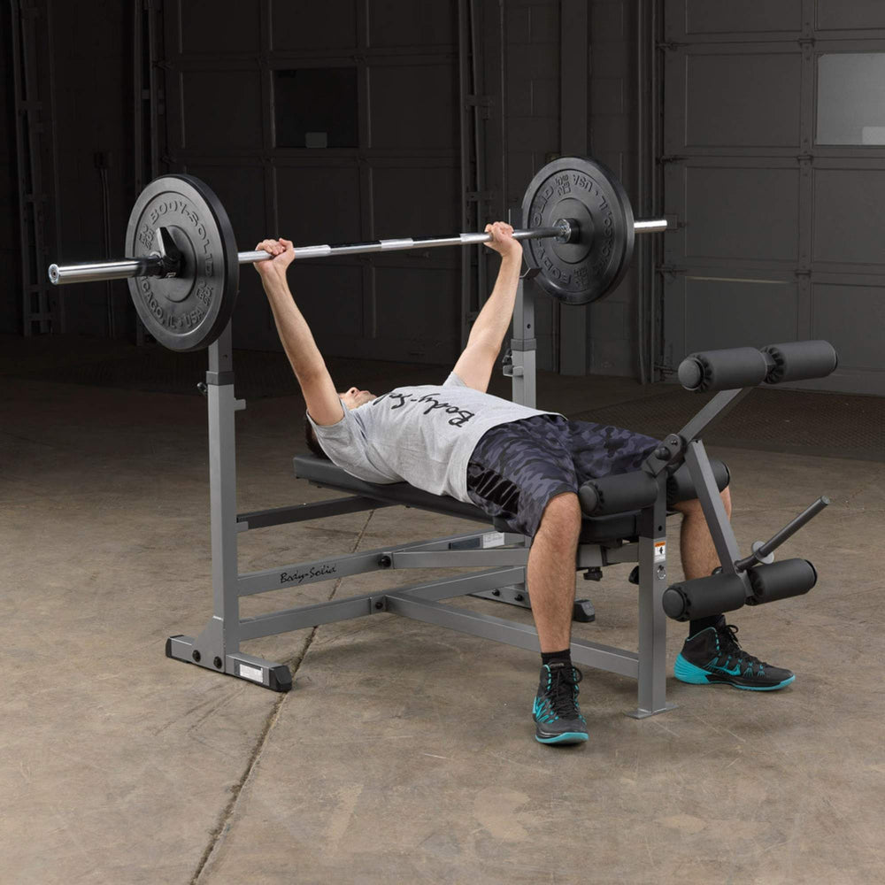 Body-Solid Powercenter Rack Bench Combo GDIB46LB Man doing flat bench press with barbell on Body-Solid bench press station