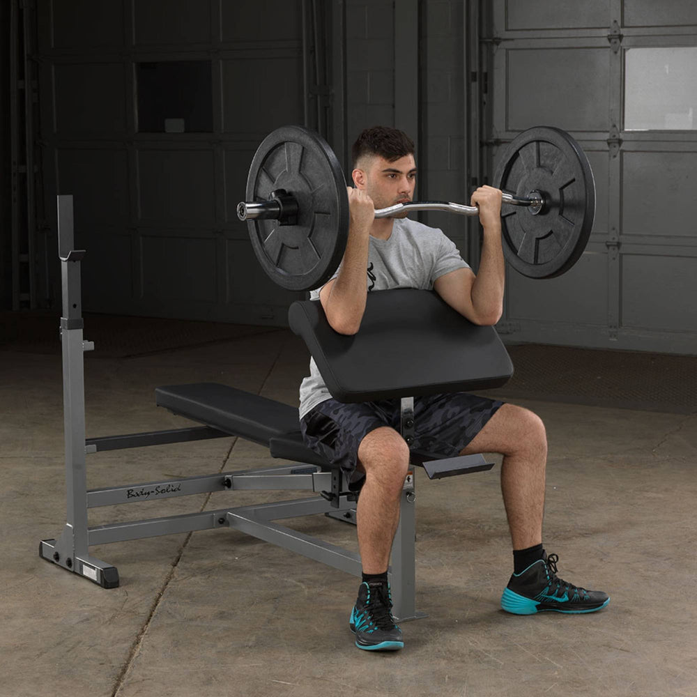 Body-Solid Powercenter Rack Bench Combo GDIB46LB Preacher curl exercise using barbell on Body-Solid bench attachment