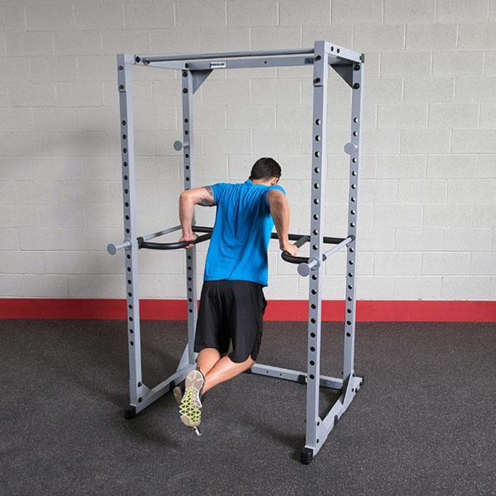 Body-Solid Powerline Dip Attachment for Power Racks DR100 a man dips performing 