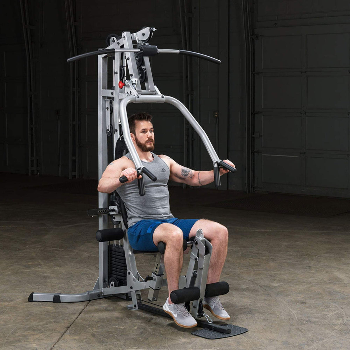 Body-Solid Powerline Multi-Station Home Gym BSG10X Man using the chest press function ,demonstrating upper body strength training