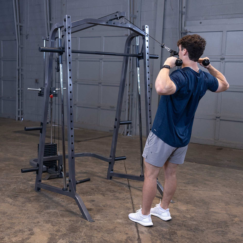 Body-Solid Powerline PSM200 Smith Machine Package PSM200P4 Man performing face pulls with cable pulley on Body-Solid Smith Machine