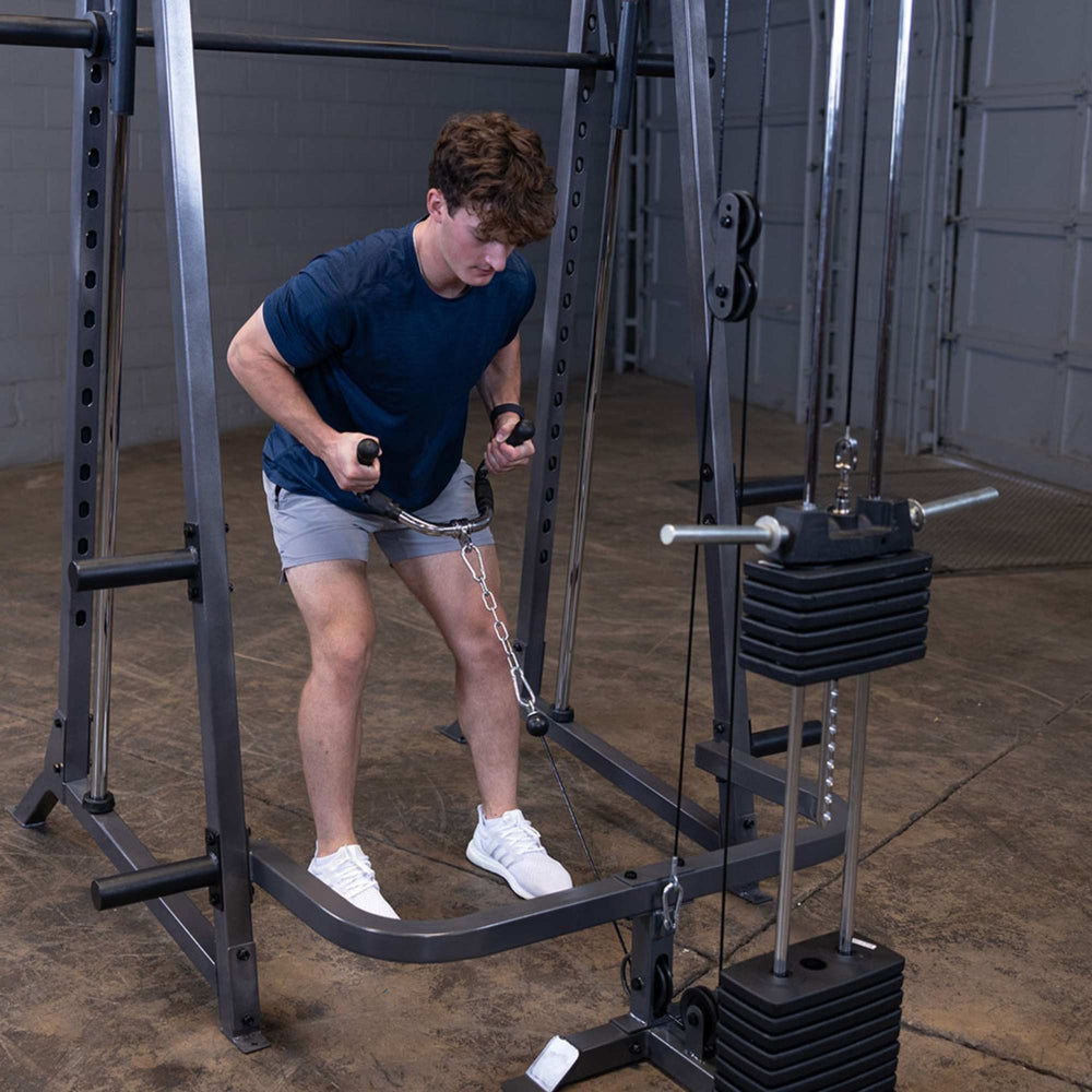 Body-Solid Powerline PSM200 Smith Machine Package PSM200P4 Man performing low cable row on Body-Solid Smith Machine