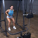 Body-Solid Powerline PSM200 Smith Machine Package PSM200P4 Woman performing squat rows on Body-Solid Smith Machine