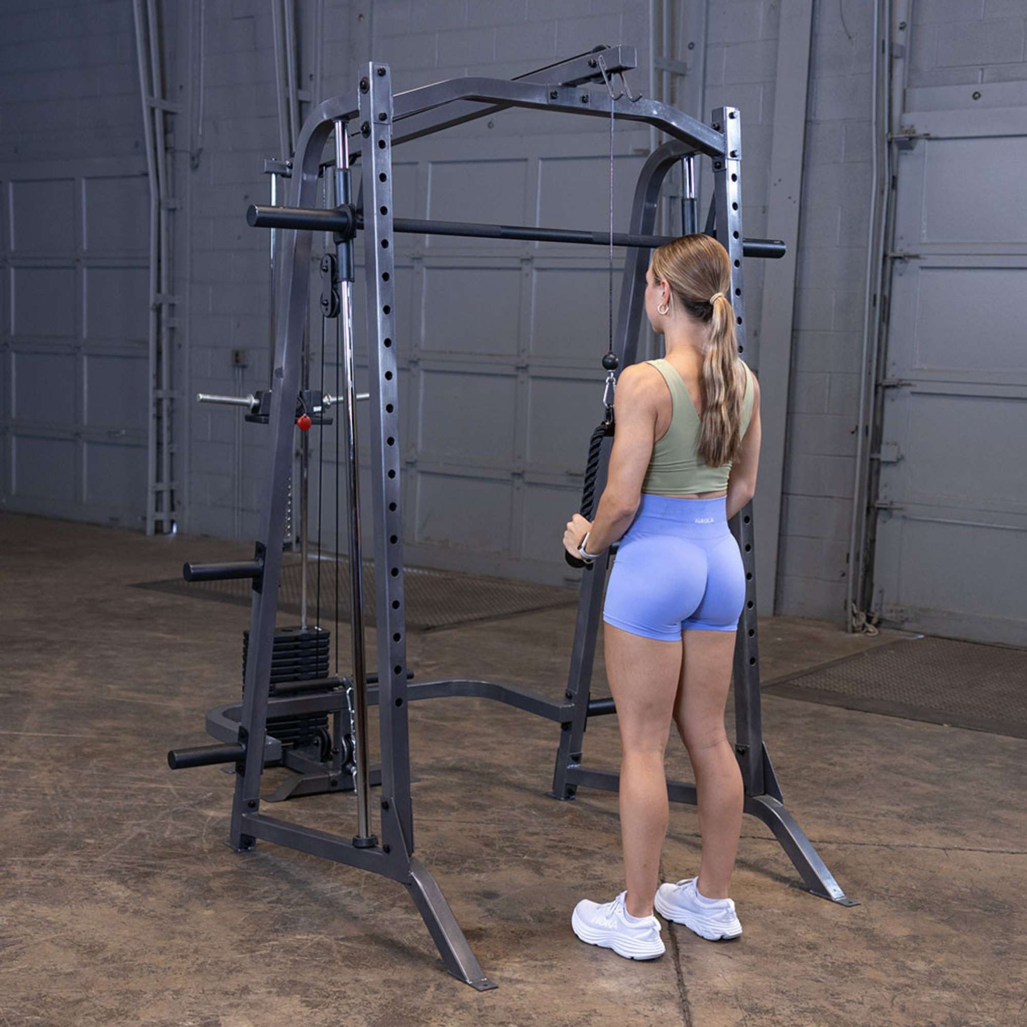 Body-Solid Powerline PSM200 Smith Machine Package PSM200P4 Woman performing triceps rope pushdowns on Body-Solid Smith Machine
