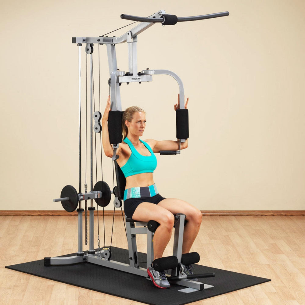 Body-Solid Powerline Plate Load Multi-Station Gym PHG1000X Woman beginning a chest fly exercise