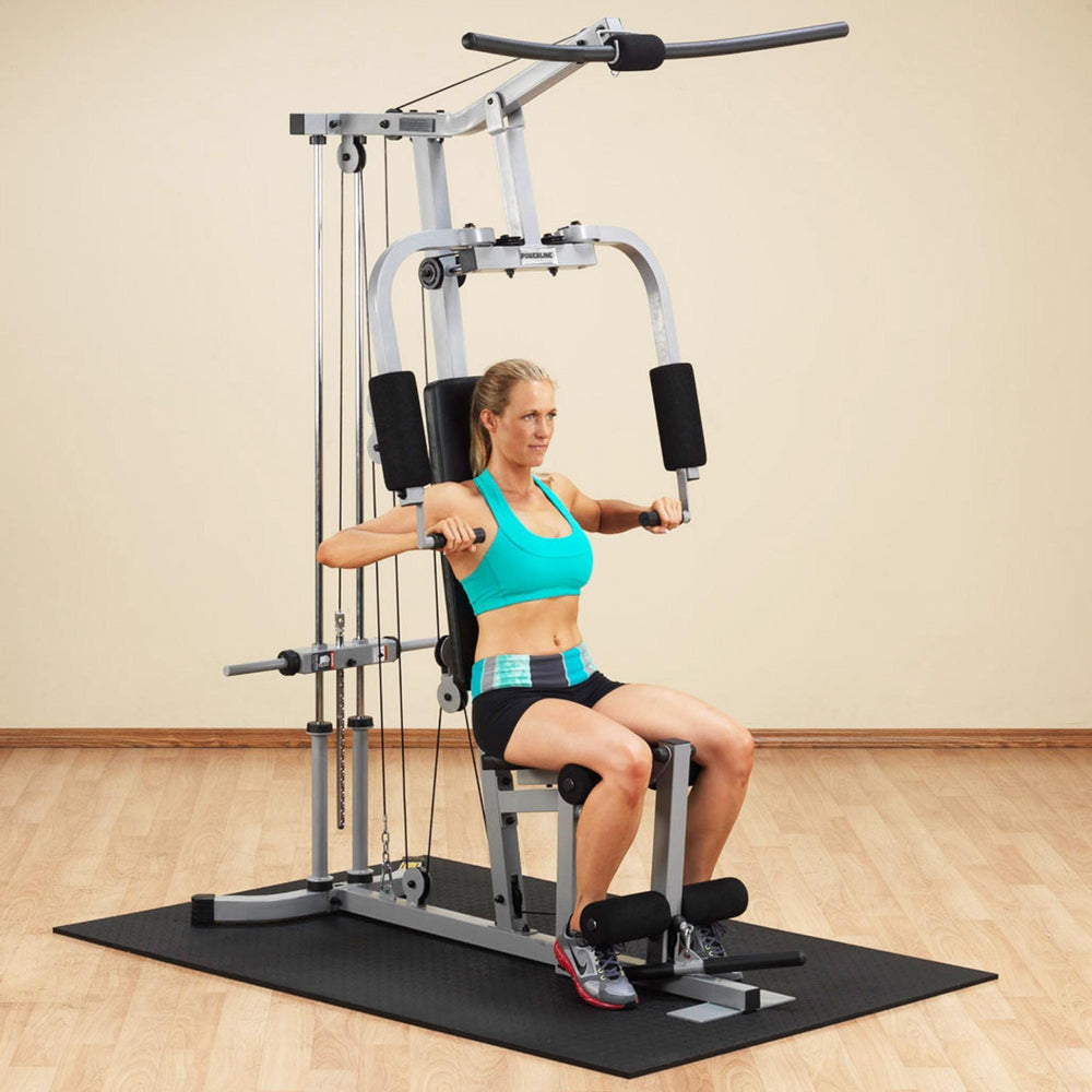 Body-Solid Powerline Plate Load Multi-Station Gym PHG1000X Woman performing chest press exercise