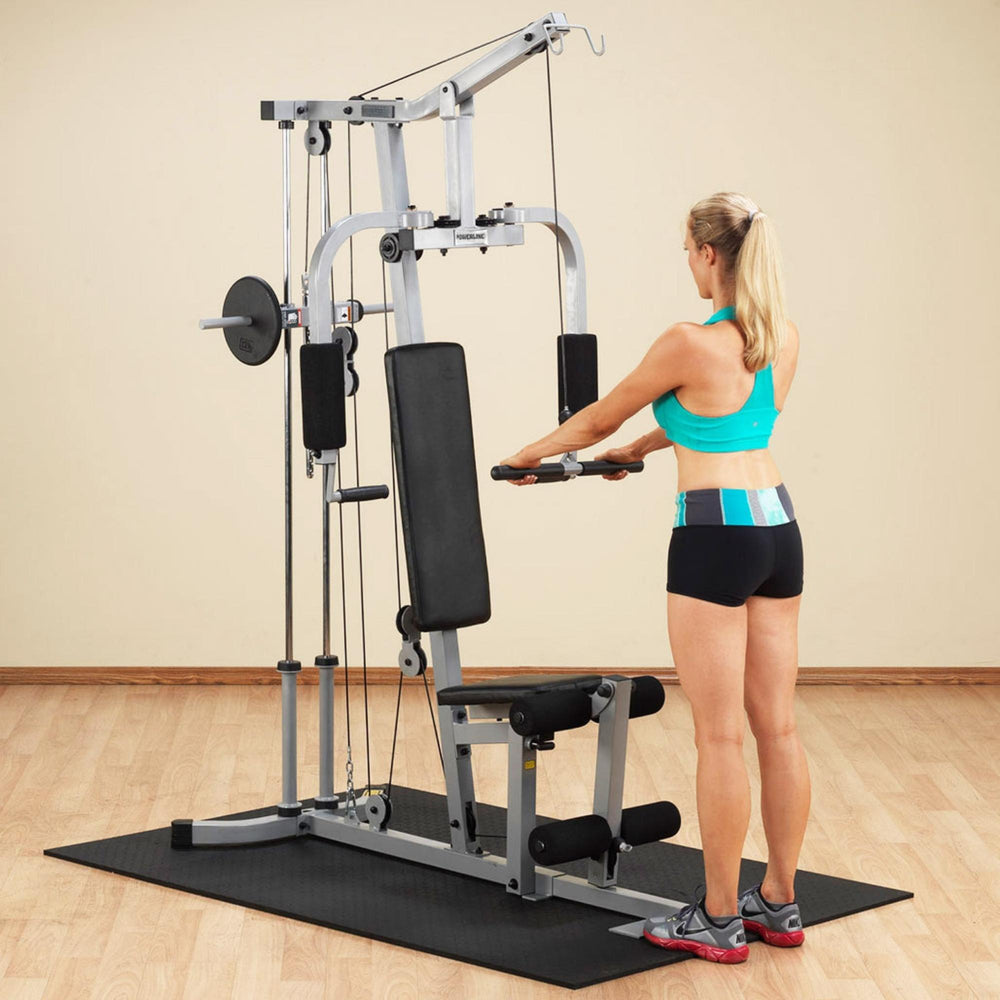 Body-Solid Powerline Plate Load Multi-Station Gym PHG1000X Woman performing tricep pushdown using Body-Solid home gym machine while standing