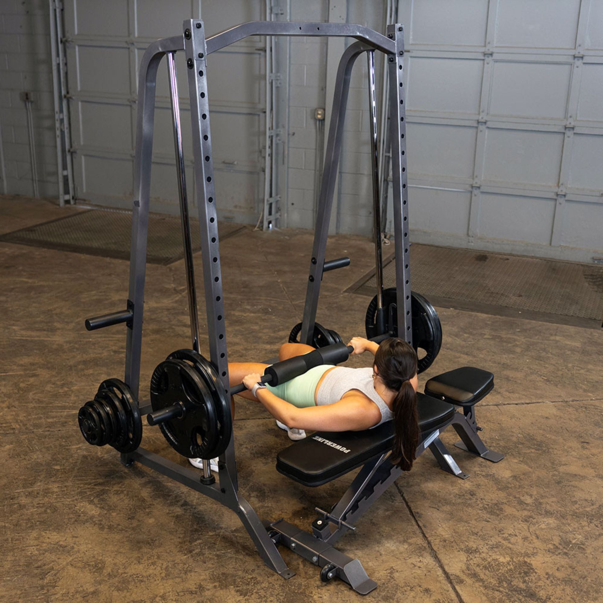 Body-Solid Powerline Smith Machine PSM200 Hip thrust glute bridge performed on Body-Solid Smith machine with padded barbell