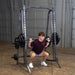 Body-Solid Powerline Smith Machine PSM200 Man executing barbell squats on Body-Solid Smith machine for leg training

