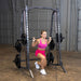 Body-Solid Powerline Smith Machine PSM200 Woman doing barbell lunges on Body-Solid Smith machine for lower body toning