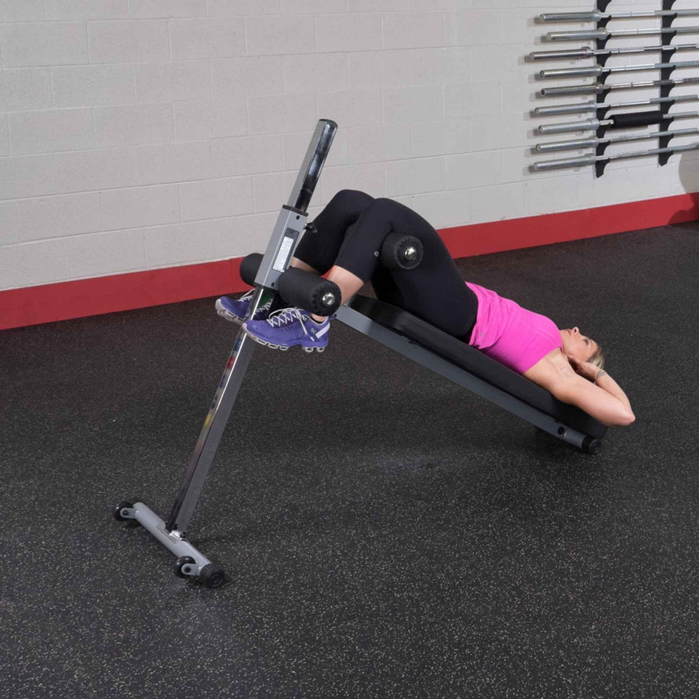 Body-Solid Pro-Style Adjustable Ab Board GAB60B Incline sit-up position with hands behind head on ab bench