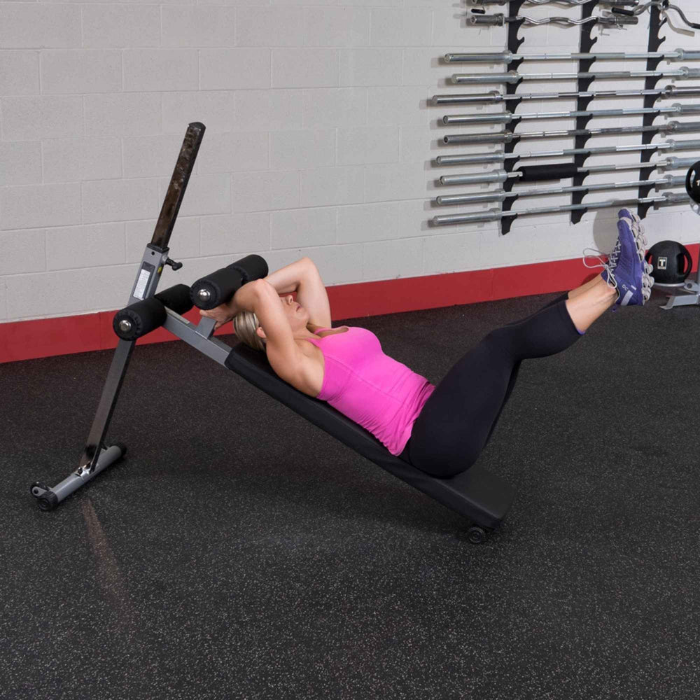 Body-Solid Pro-Style Adjustable Ab Board GAB60B Reverse crunch with legs elevated on Body-Solid incline bench