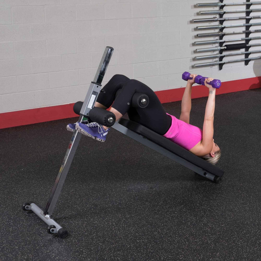 Body-Solid Pro-Style Adjustable Ab Board GAB60B Woman using ab bench for incline dumbbell chest press