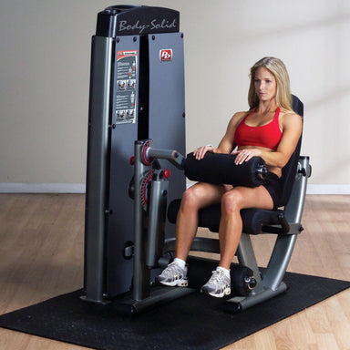 Body-Solid ProDual Leg Extension Curl Machine with Weight Stack DLECSF Woman performing seated leg curl