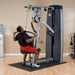 Body-Solid ProDual Press Arm Lat Machine With Weight Stack DPLSSF Man executing lat pulldown 