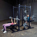 Body-Solid Pro ClubLine Double Half Rack SPR500DBL Man doing pull-ups while woman performs bench press on Body-Solid SPR500DBL Commercial Half Rack, showing dual workout setup.
