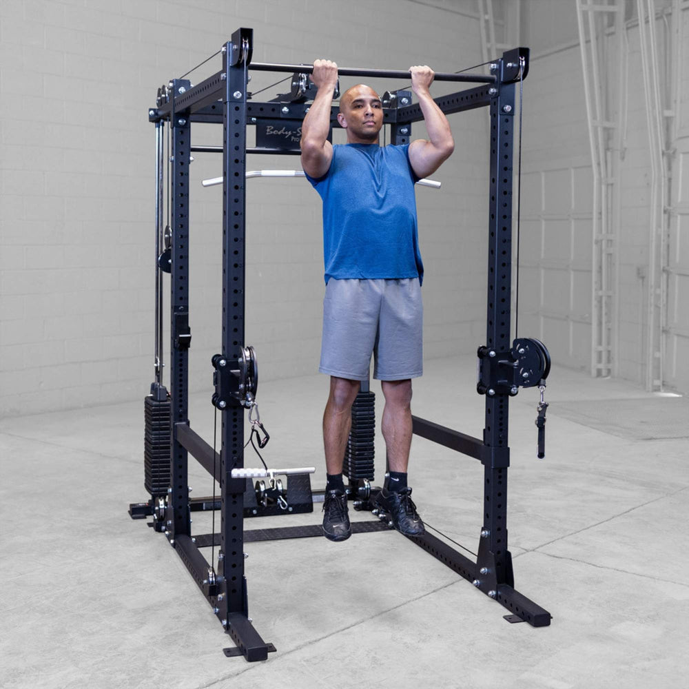 Body-Solid Pro ClubLine Functional Trainer Attachment SPRFTS Man doing pull-up exercise on integrated pull-up bar of Body-Solid Pro ClubLine SPRFTS power rack.

