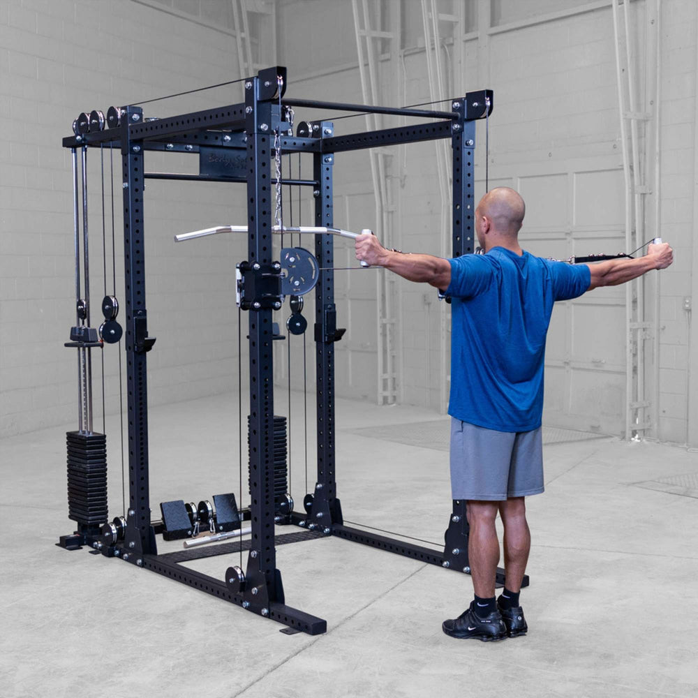 Body-Solid Pro ClubLine Functional Trainer Attachment SPRFTS Man doing rear delt cable fly exercise using dual pulley system on Body-Solid Pro ClubLine SPRFTS.

