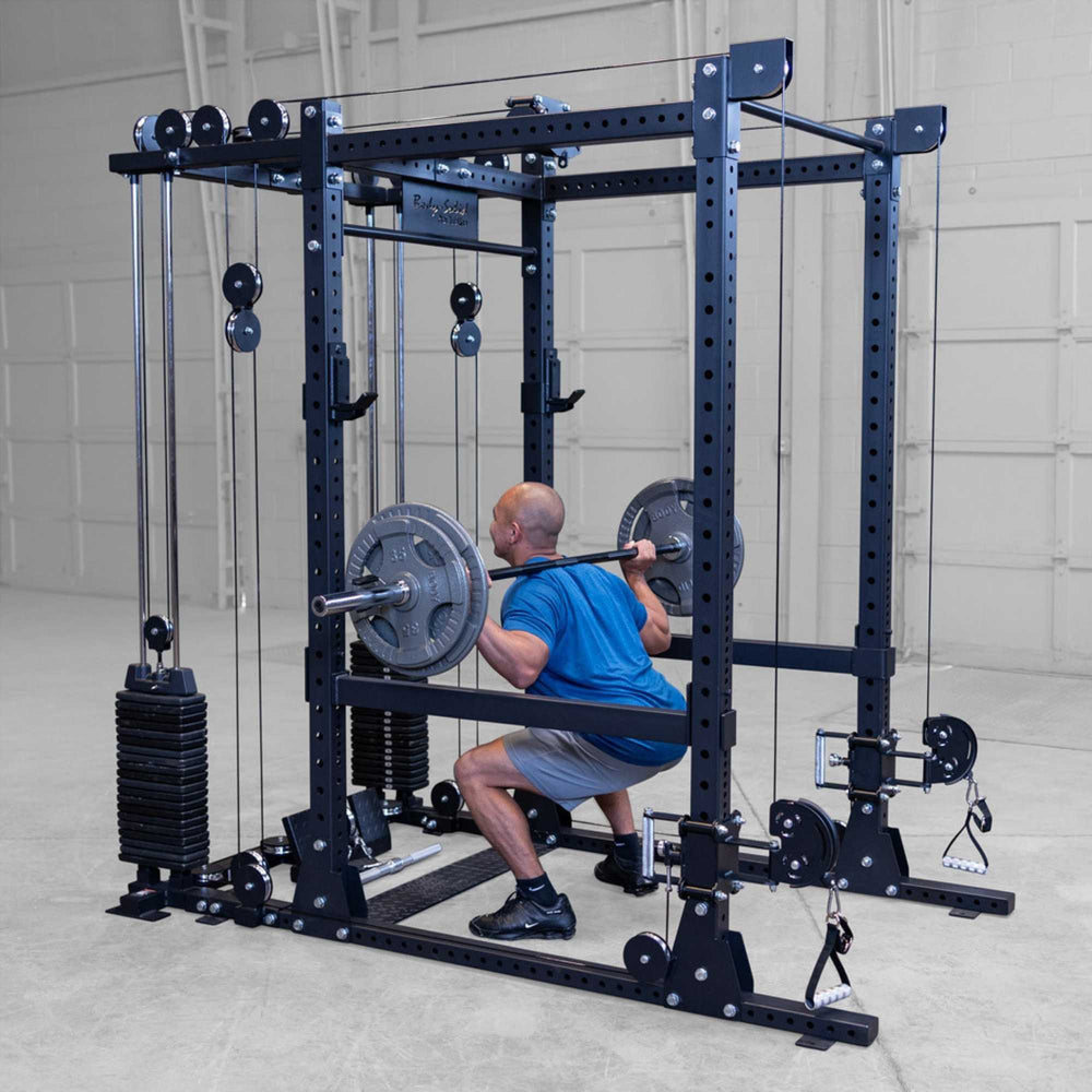Body-Solid Pro ClubLine Functional Trainer Attachment SPRFTS Man executing back squat with barbell on Body-Solid SPRFTS power rack functional trainer system.
