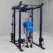 Body-Solid Pro ClubLine Functional Trainer Attachment SPRFTS Man executing triceps pushdown with cable and straight bar attachment on Body-Solid SPRFTS system.
