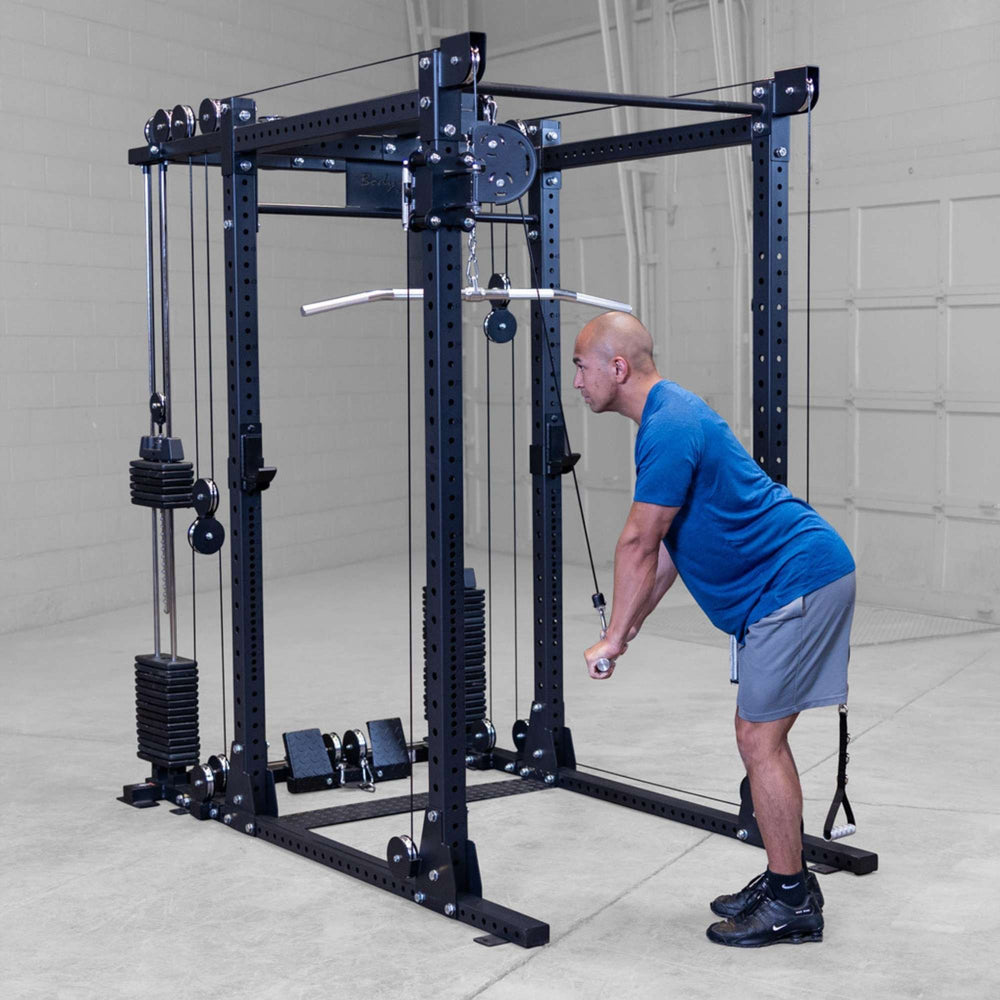 Body-Solid Pro ClubLine Functional Trainer Attachment SPRFTS Man performing standing triceps extension using high pulley and straight bar on Body-Solid SPRFTS functional trainer system.