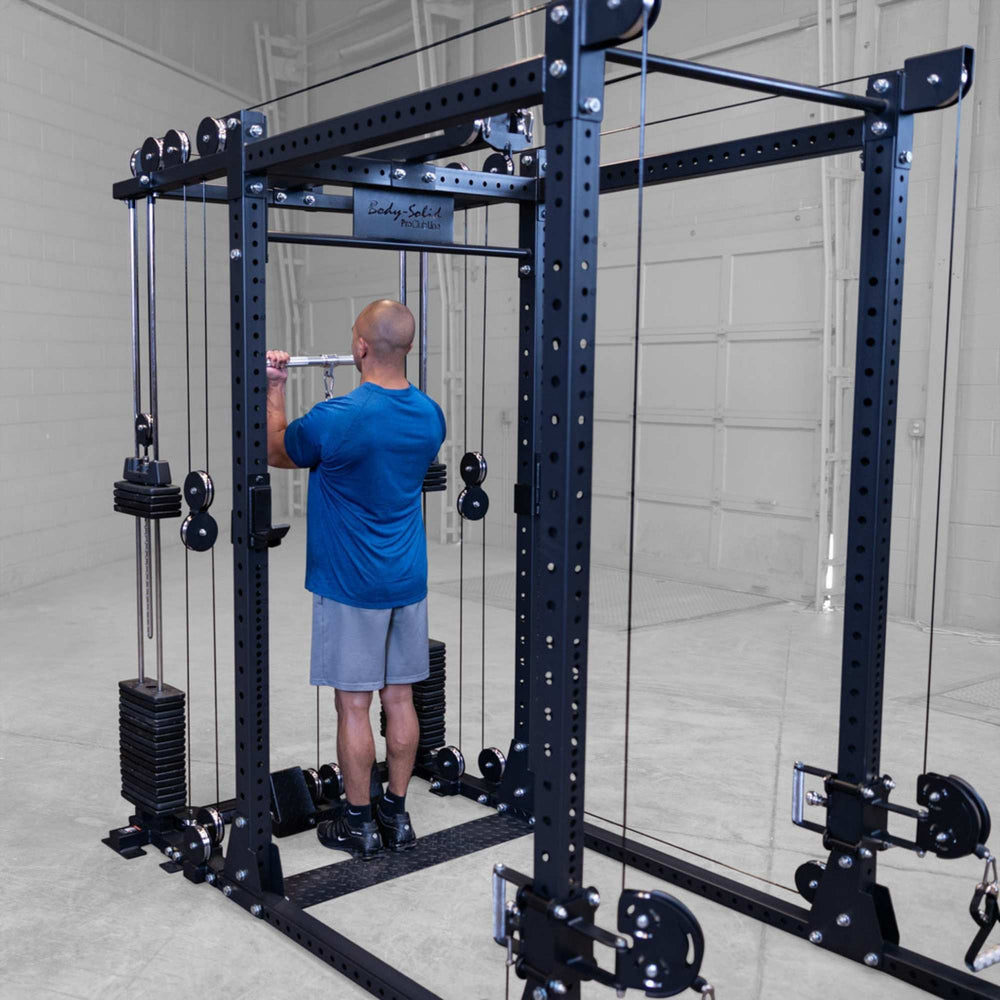 Body-Solid Pro ClubLine Functional Trainer Attachment SPRFTS Man performing triceps pushdown exercise using cable and straight bar attachment on Body-Solid SPRFTS functional trainer.
