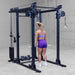 Body-Solid Pro ClubLine Functional Trainer Attachment SPRFTS Woman executing standing cable chest fly exercise using dual pulleys on Body-Solid SPRFTS functional trainer.

