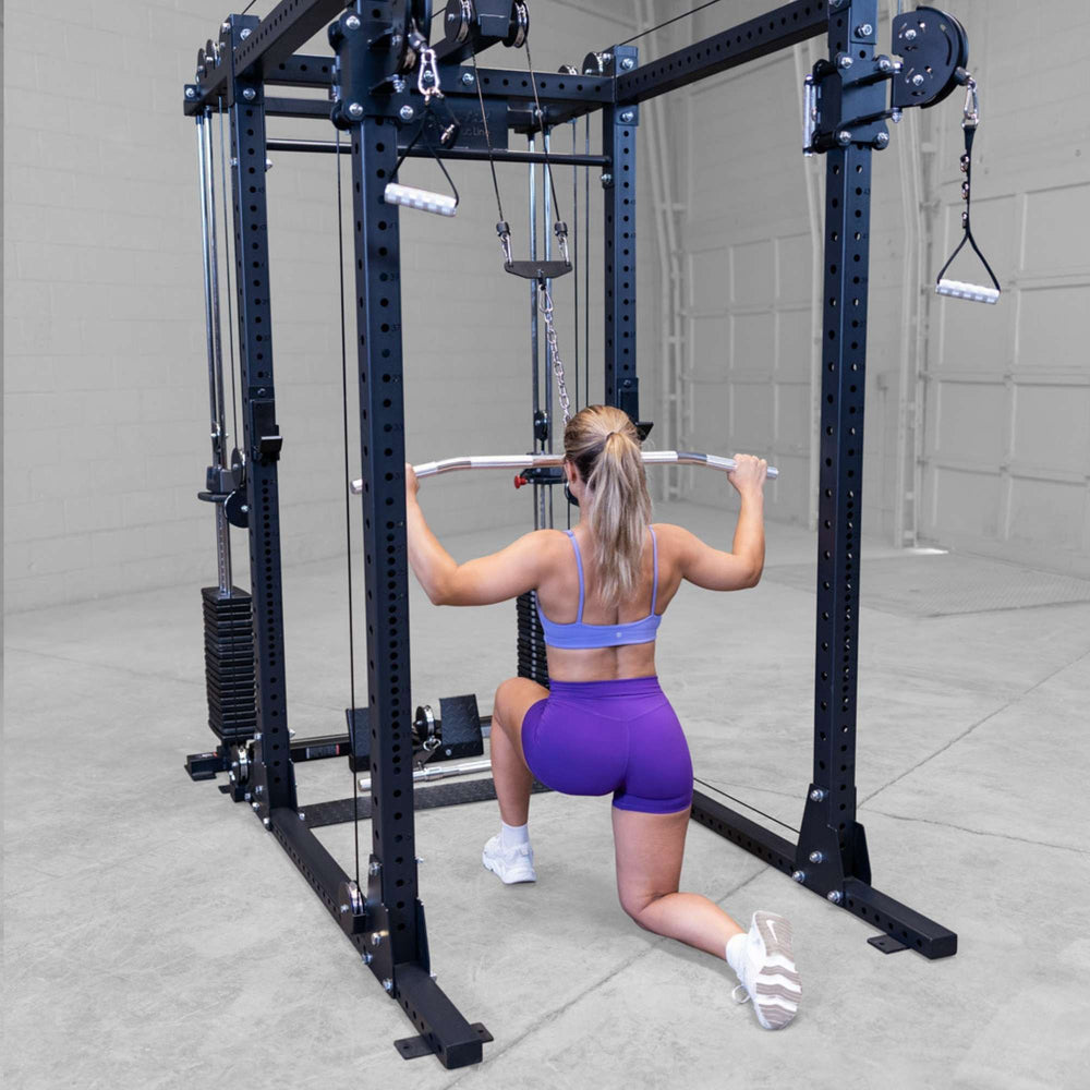 Body-Solid Pro ClubLine Functional Trainer Attachment SPRFTS Woman performing kneeling wide-grip lat pulldown on Body-Solid Pro ClubLine SPRFTS functional trainer.