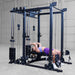 Body-Solid Pro ClubLine Functional Trainer Attachment SPRFTS Woman performing lying cable pullover on adjustable bench inside Body-Solid Pro ClubLine SPRFTS functional trainer.
