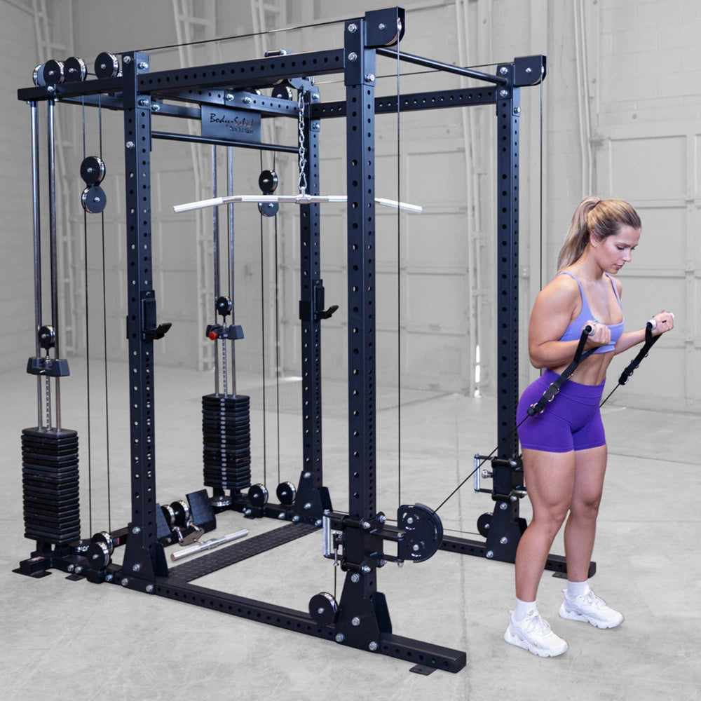 Body-Solid Pro ClubLine Functional Trainer Attachment SPRFTS Woman performing standing cable bicep curls using dual handles on Body-Solid Pro ClubLine SPRFTS functional trainer.
