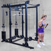 Body-Solid Pro ClubLine Functional Trainer Attachment SPRFTS Woman performing standing cable bicep curls using dual handles on Body-Solid Pro ClubLine SPRFTS functional trainer.
