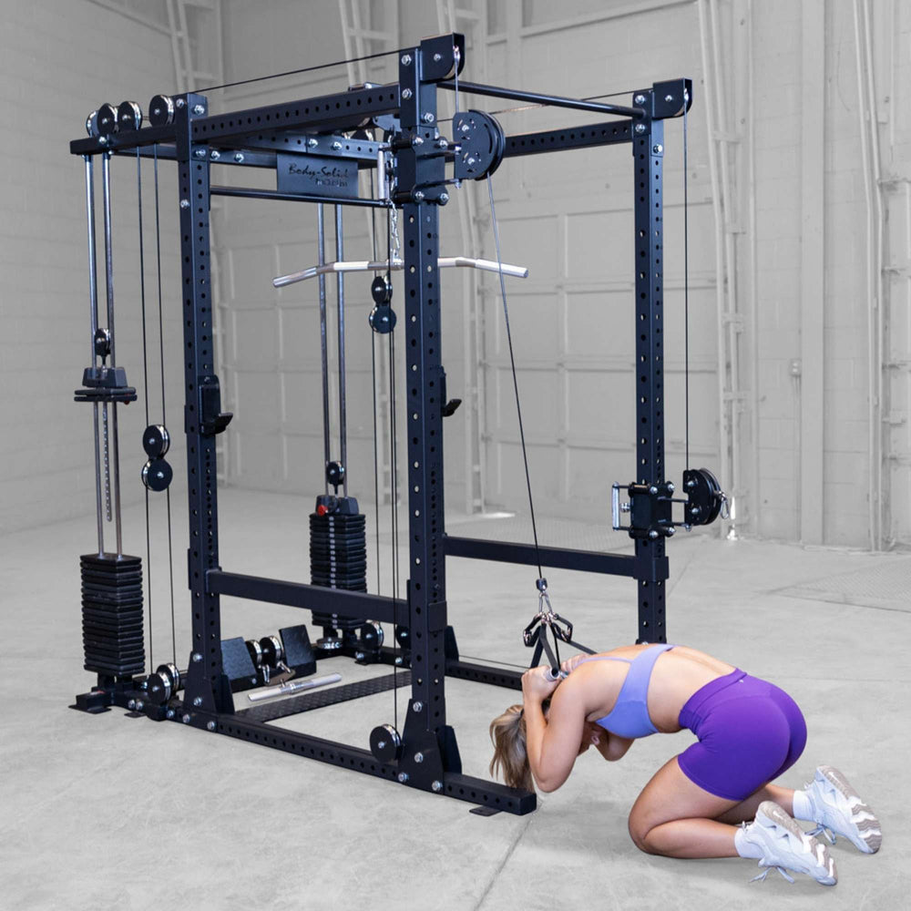 Body-Solid Pro ClubLine Functional Trainer Attachment SPRFTS Woman performing standing cable high-to-low cross movement in squat stance on Body-Solid Pro ClubLine SPRFTS.
