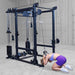 Body-Solid Pro ClubLine Functional Trainer Attachment SPRFTS Woman performing standing cable high-to-low cross movement in squat stance on Body-Solid Pro ClubLine SPRFTS.
