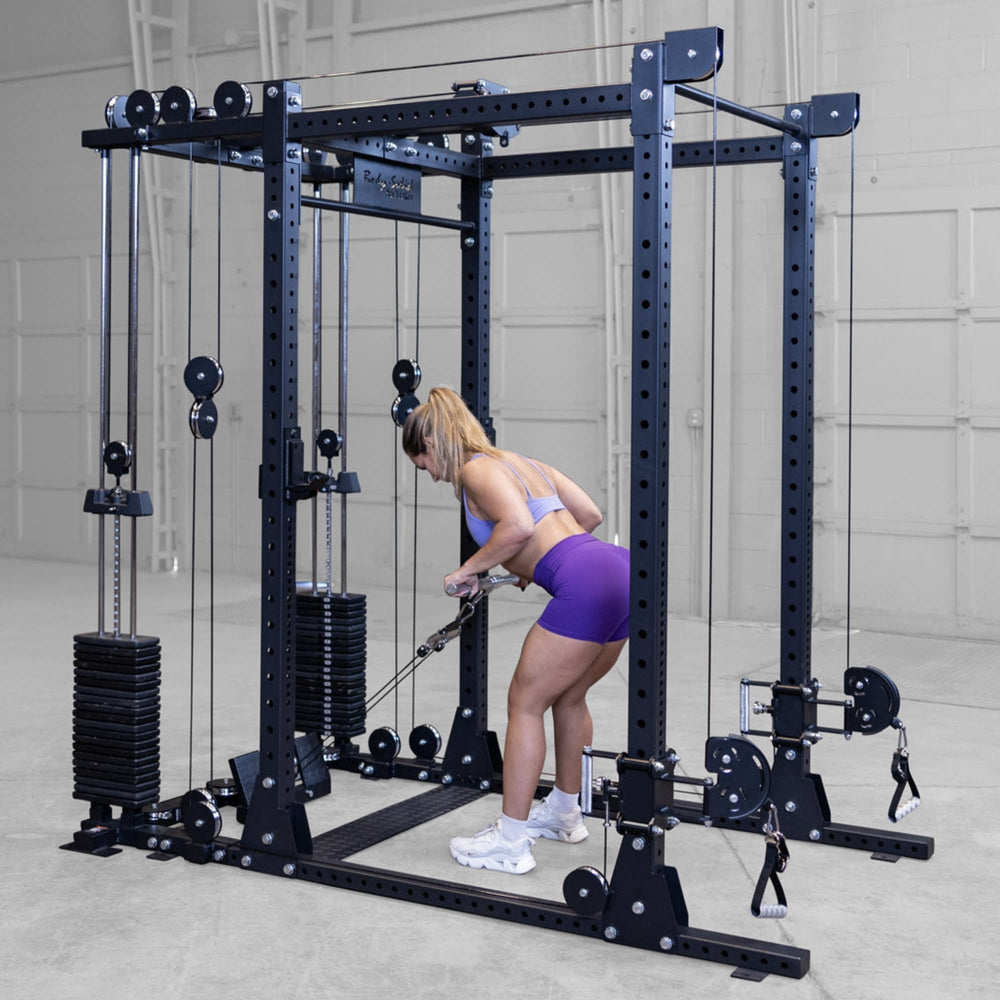 Body-Solid Pro ClubLine Functional Trainer Attachment SPRFTS Woman performing standing single-arm cable curl facing weight stacks on Body-Solid SPRFTS functional trainer.
