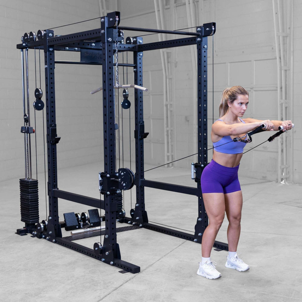 Body-Solid Pro ClubLine Functional Trainer Attachment SPRFTS Woman standing behind Body-Solid Pro ClubLine SPRFTS trainer preparing for barbell triceps pushdown.
