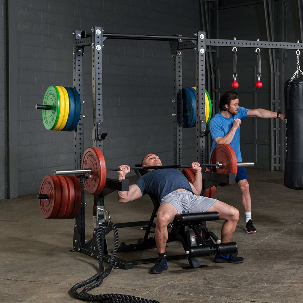 Body-Solid Pro ClubLine Half Rack with Rear Extension SPR500BACK Bench pressing and boxing workout happening beside  rack