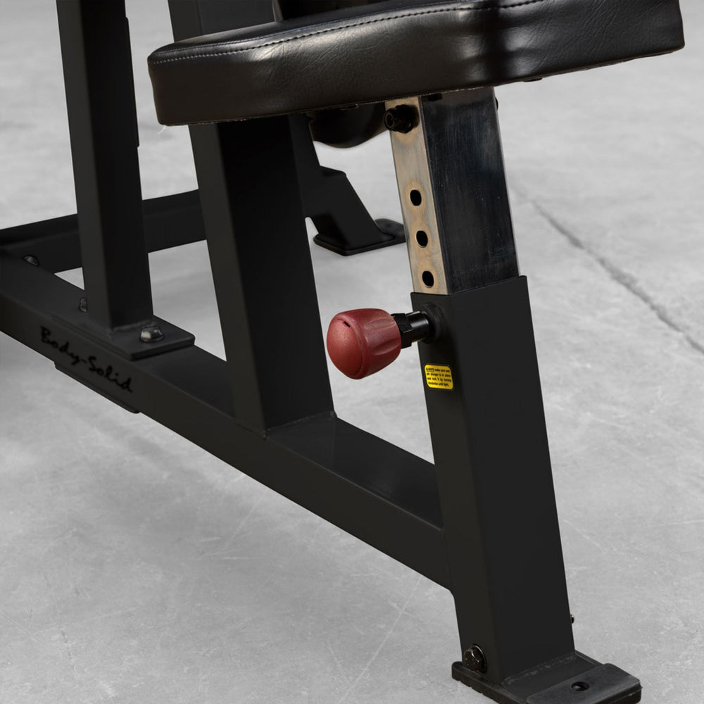 Body-Solid Pro ClubLine LVSP Leverage Shoulder Press LVSPB Detail shot of Body-Solid LVSP adjustable seat post featuring red adjustment knob and steel support column