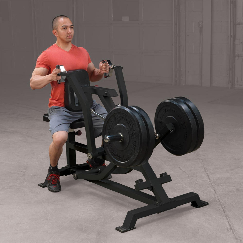 Body-Solid Pro ClubLine LVSR Leverage Seated Row LVSRB Man extending arms forward during plate-loaded seated row workout on Body-Solid LVSR, demonstrating smooth range of motion and ergonomic handles.
